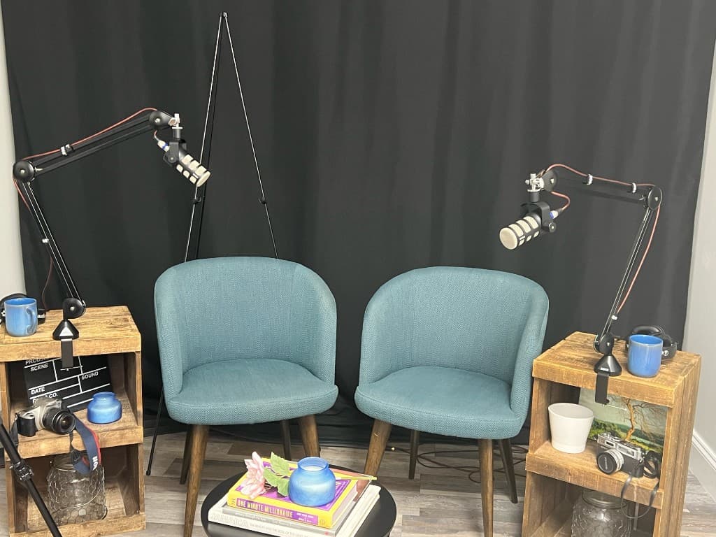 TopNotch Studios podcast setup with teal chairs and microphones